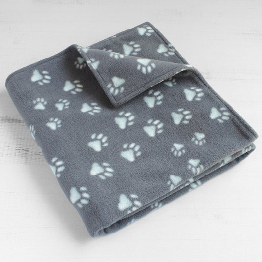 Dog blanket with grey background and lightly tinted blue paw prints.