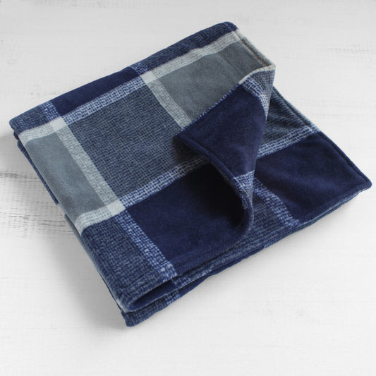 Dog blanket folded up with navy and grey plaid pattern on both sides.