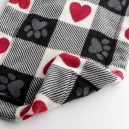 Closeup of cat mat in red, white, and black squares. Some squared have red hearts and some have gray paws. The front and back are the same.